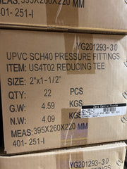 A close-up of stacked cardboard shipping boxes for UPVC SCH40 pressure fittings, specifically reducing tee items with printed product details and a barcode label.