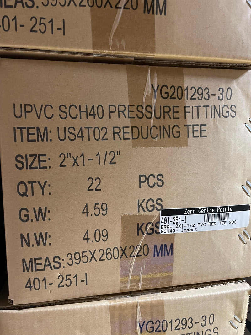 A close-up of stacked cardboard shipping boxes for UPVC SCH40 pressure fittings, specifically reducing tee items with printed product details and a barcode label.