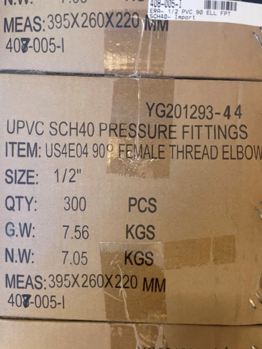 A close-up of a brown cardboard shipping box printed with product details for UPVC SCH40 pressure fittings, including item code YG201293-4 4, 1/2" female thread elbow, quantity 300 PCS, and dimensions 395x260x220 mm.