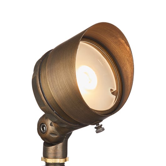 A bronze-colored LED spotlight with a round shape and a visible bulb inside, designed for landscape pathway lighting.