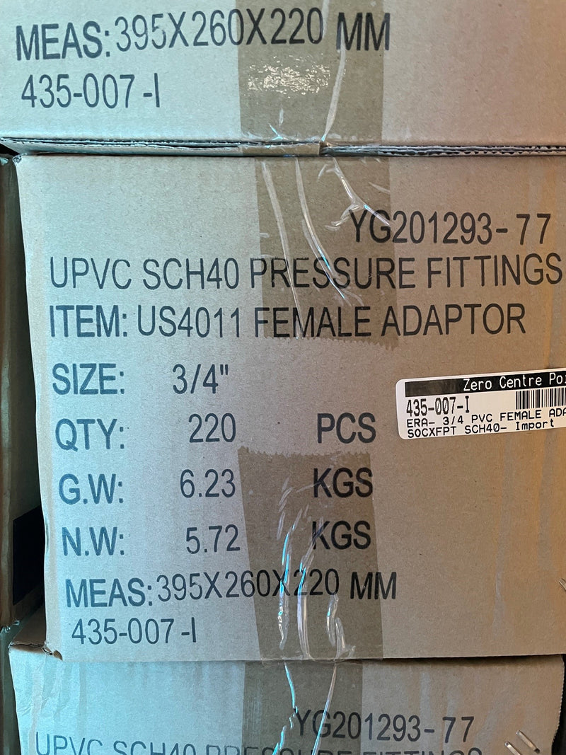 A close-up of a cardboard shipping box printed with product details for UPVC SCH40 pressure fittings, specifically a female adapter, with dimensions, quantity, and weight listed in black text.