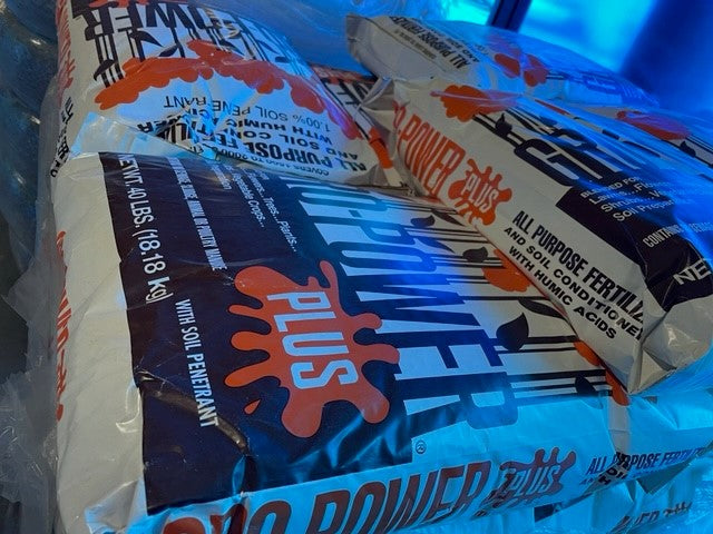 Bags of fertilizer with branding and text.