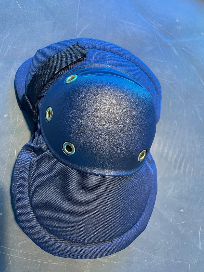 Blue knee pad on a metallic surface