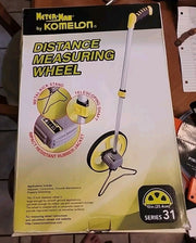 Boxed Kometon Distance Measuring Wheel, Series 31, shown in its retail packaging with product graphics and features printed on the front.