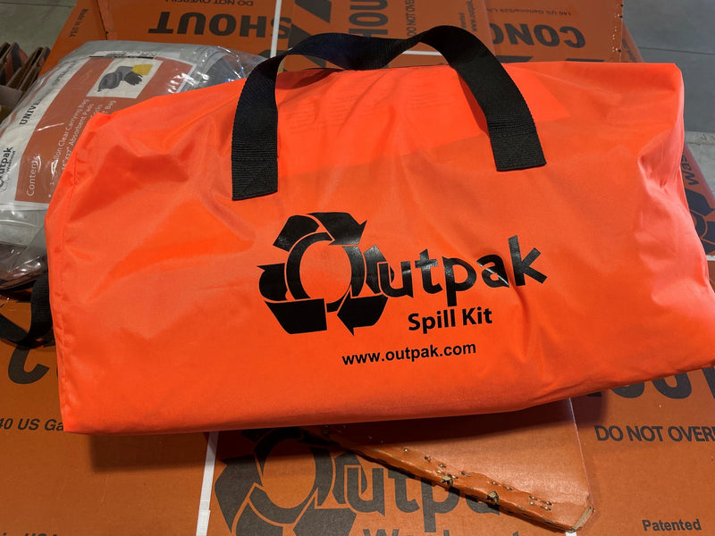 Orange Outpak Spill Kit bag on a cardboard surface