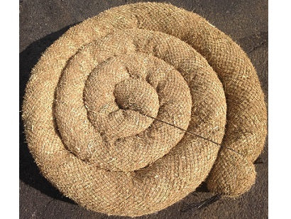 A roll of straw wattle, a weed-free fiber product used for erosion control, lying on the ground.